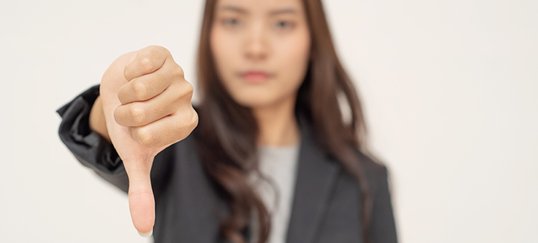 Woman holding a thumbs down