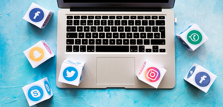 Laptop with social media icons around it