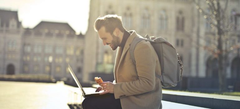 Man with laptop outside