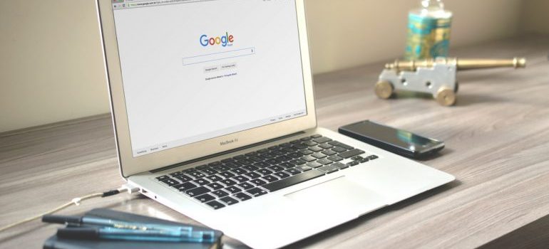 Laptop with Google search bar and phone