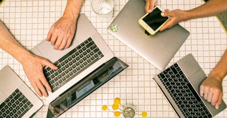 People on laptops and phones.