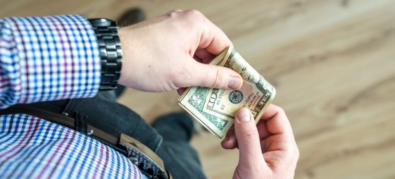 Person holding dollar bills in hands