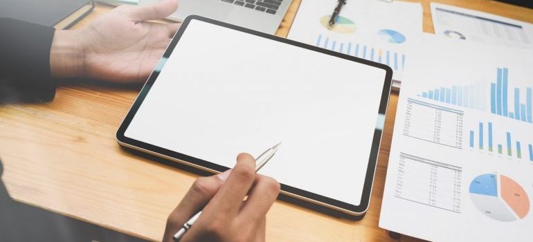 A person using statistical data to measure paid social media advertising benefits