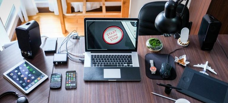 Laptop on wide work space with Start button on screen.