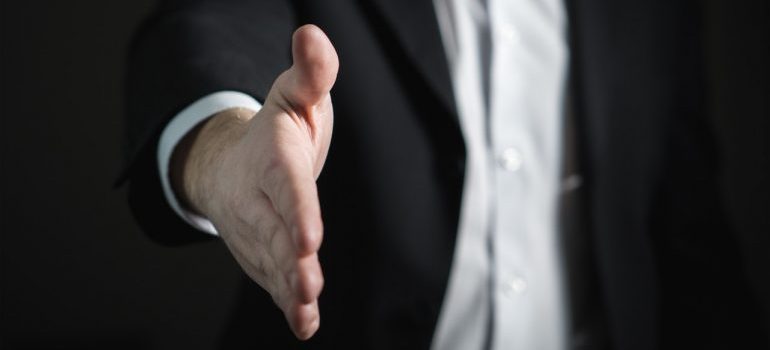 Image of a businessman offering a handshake.