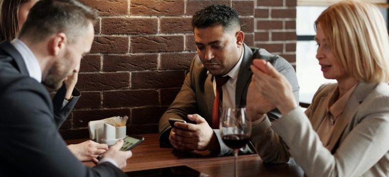 People looking at emails on their phones.