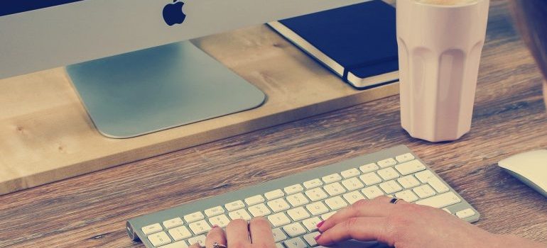 a person typing on apple keyboard