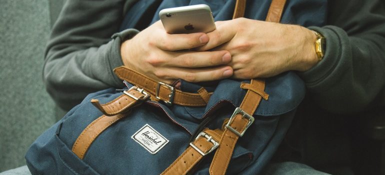 a person holding a cell phone, representing mobile PPC advertising