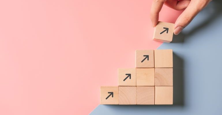 Wooden cubes with arrows to symbolize growth