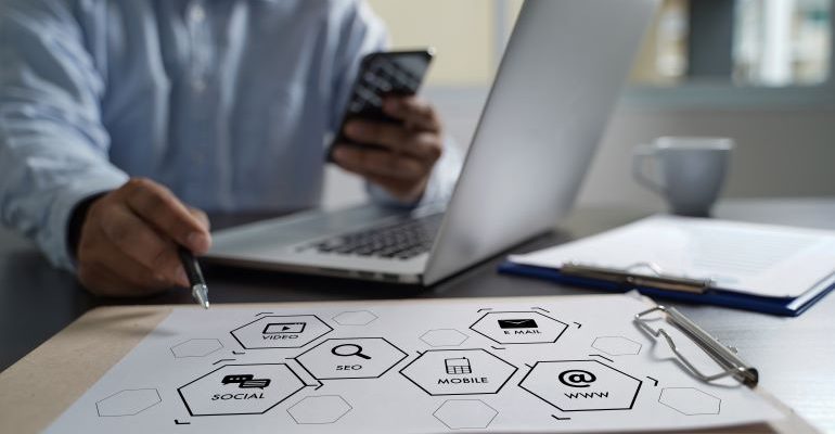 Person with a laptop and SEO metrics icons