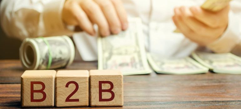 Person counting money after applying B2B digital marketing strategies.