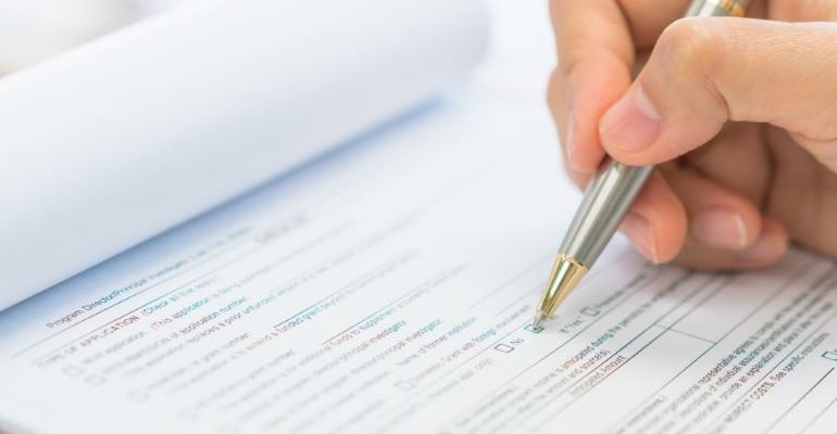 Person filling out a survey for comparative advertising.