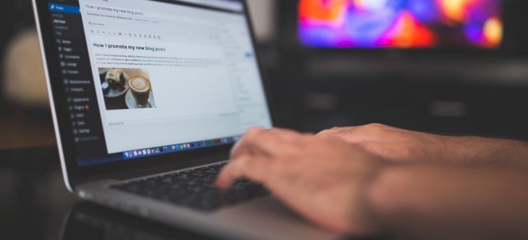 a person writing a blog post, representing reasons why your company should have a blog