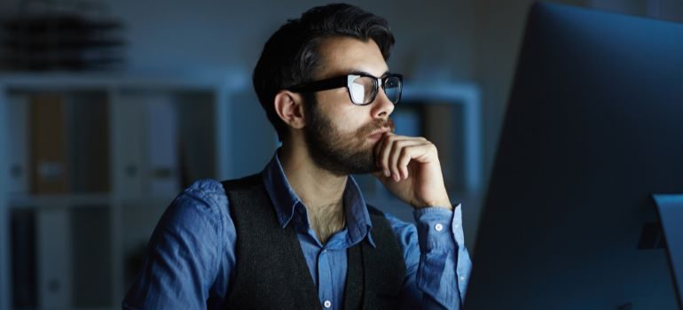 Businessman looking at laptop - one of the different types of site visitors.