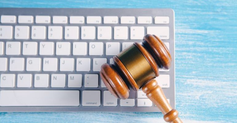 A wooden gavel on keyboard.