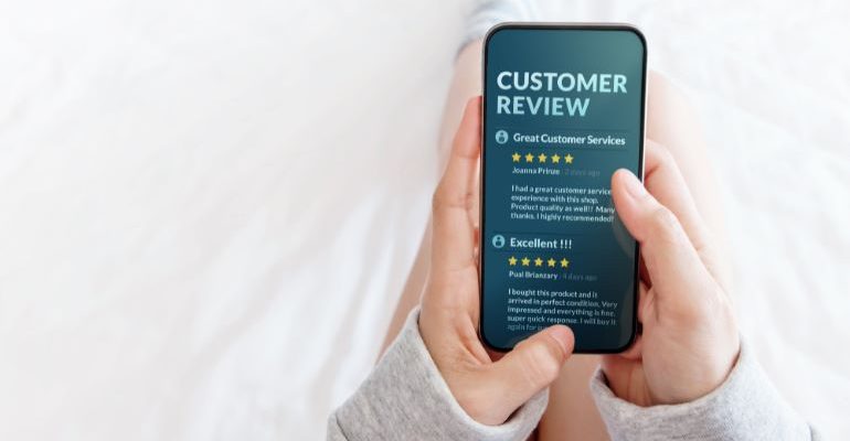 Person looking at customer reviews on a phone.