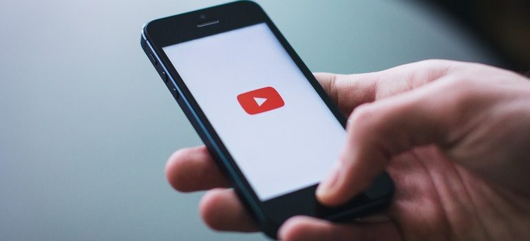 Person opening the YouTube app on mobile.