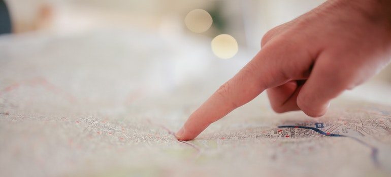 Person pointing at a place on a map