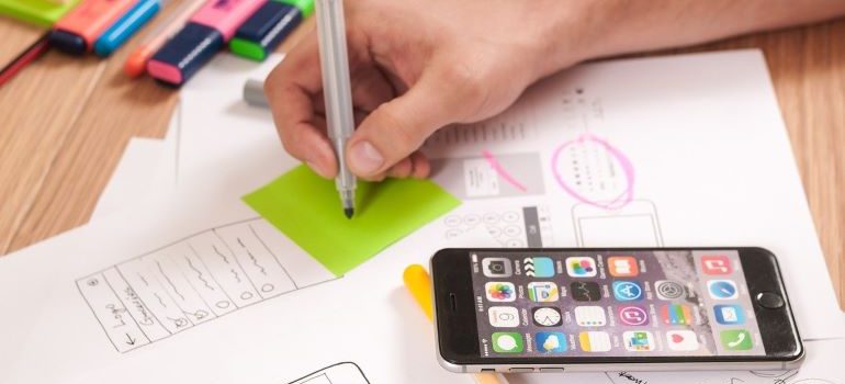 Person writing down marketing ideas for the off-season.