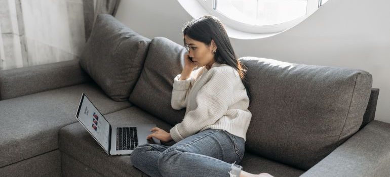 Girl at home, looking at her laptop.