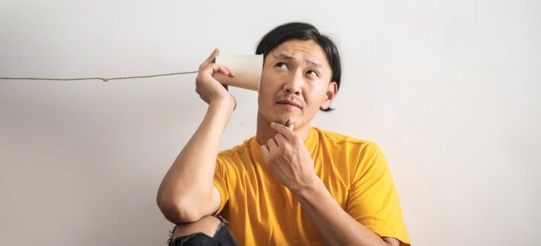 Man listening for an answer to his voice search.