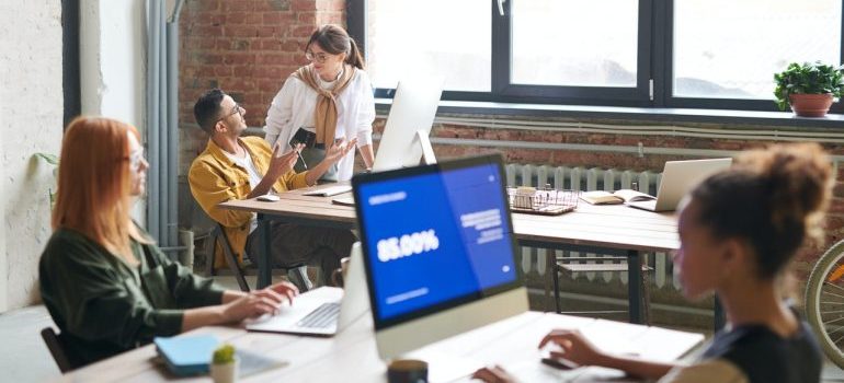 Employees areeing on a B2B sale.