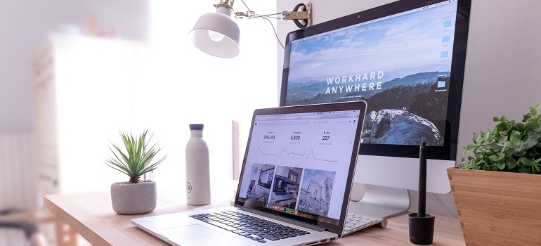 Laptop and desktop computer loading website page.