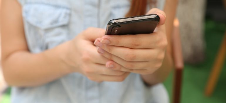 A woman holding her phone.