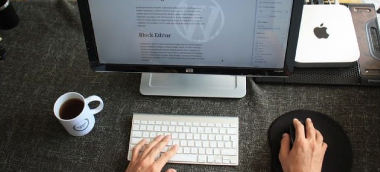 Person sitting at a computer and typing a blog