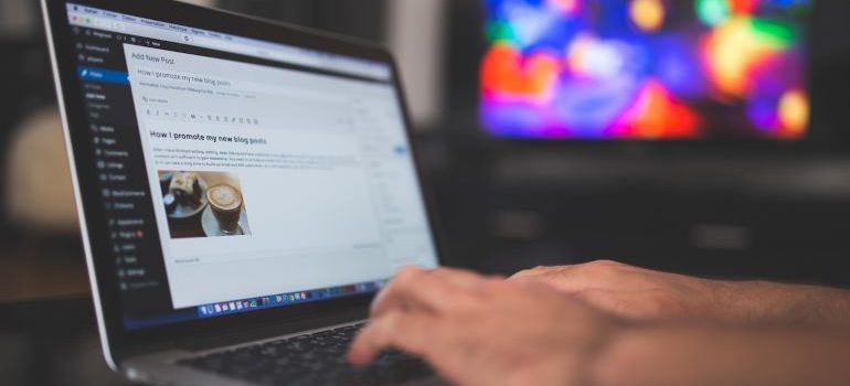 Photo of person's hands while typing a blog in WordPress on their laptop