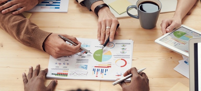 Employees looking at Account-based marketing statistics and results.