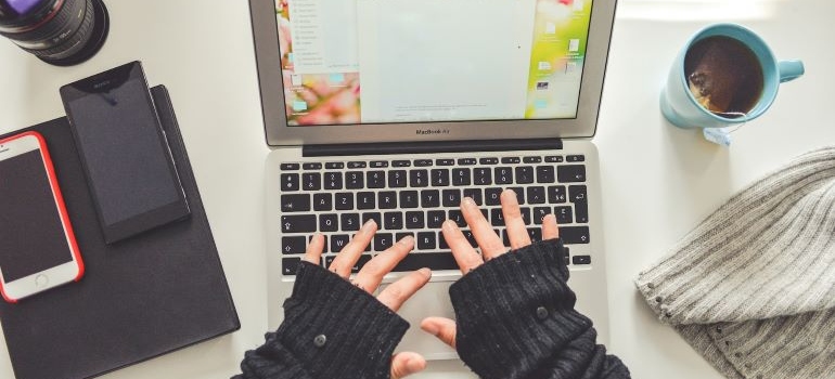 Person wearing black gloves typing a document in Microsoft Office Word