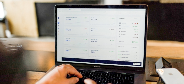 Person typing on a laptop and looking at Google Analytics page