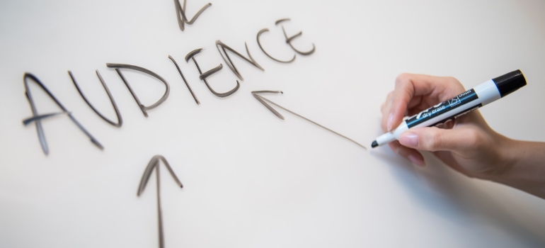 Person drawing on a white board using a marker