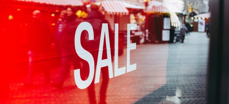 A sale sign outside of a shop during the holiday season.