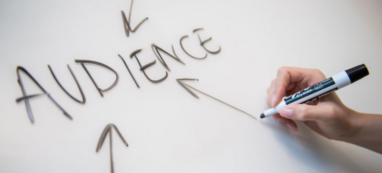 An individual drawing arrows to the word Audience.