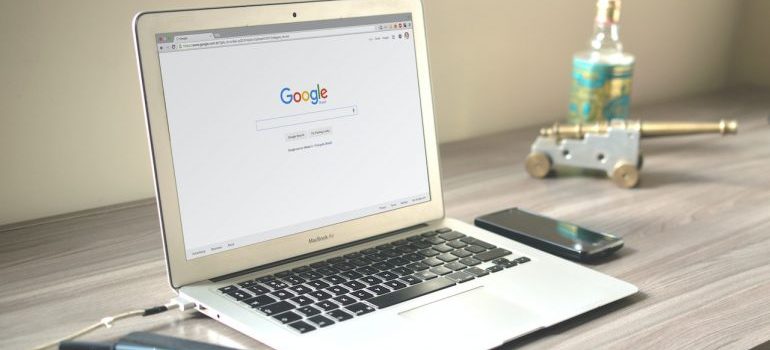 Google search page opened on a laptop that sitting upon the desk.
