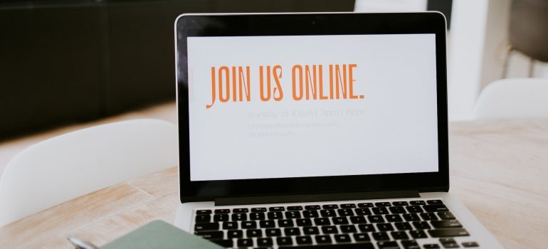 A laptop showing the word ''join us online'' on the screen.
