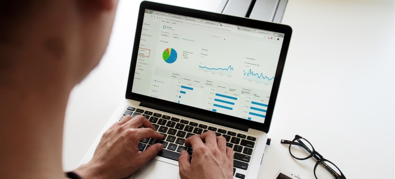 Person using a laptop to analyze data and debunk biggest SEO myths in 2022