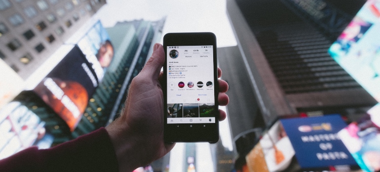 Person using Instagram on their phone at Times Square