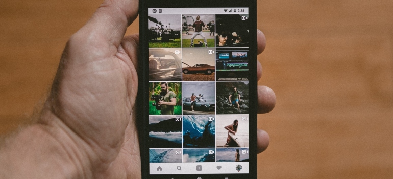 Person holding a phone with Instagram marketing reels opened on it