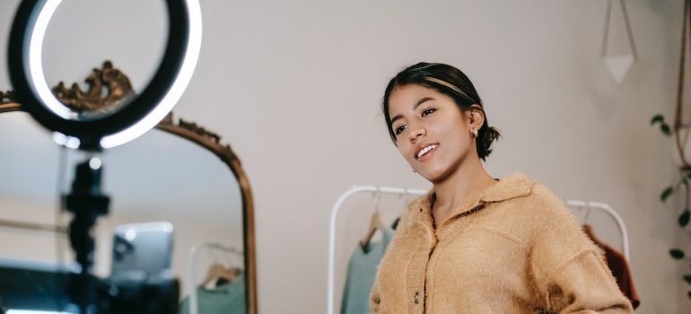 An influencer recording a video in their room