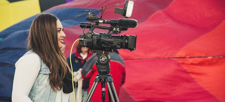 a woman standing behind a camera