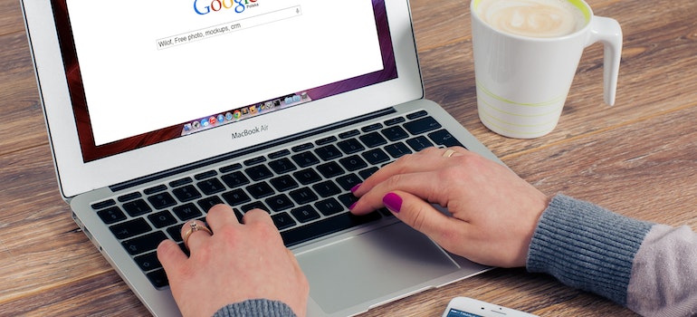 A person with the laptop about to read about PPC trends for 2023