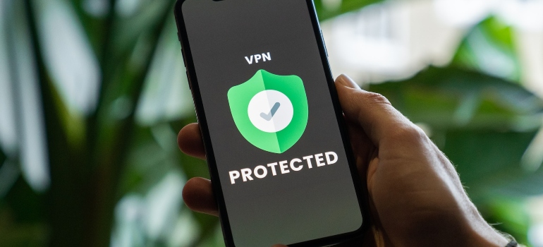 Person holding a smartphone with VPN protected screen on it