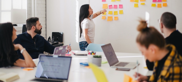 Marketing team having a meeting in an office and discussing customizing PPC ads for mobile