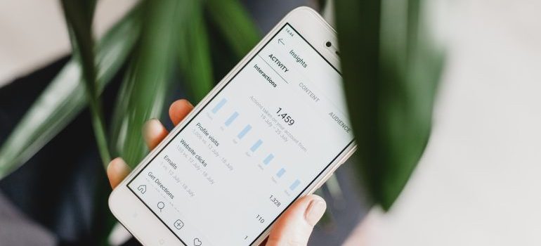A person checking insights on Instagram after deciding between Instagram or Facebook ads for your business