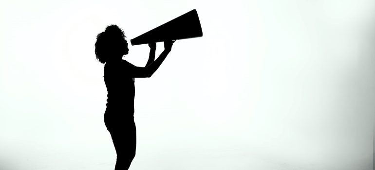 A silhouette of a woman shouting