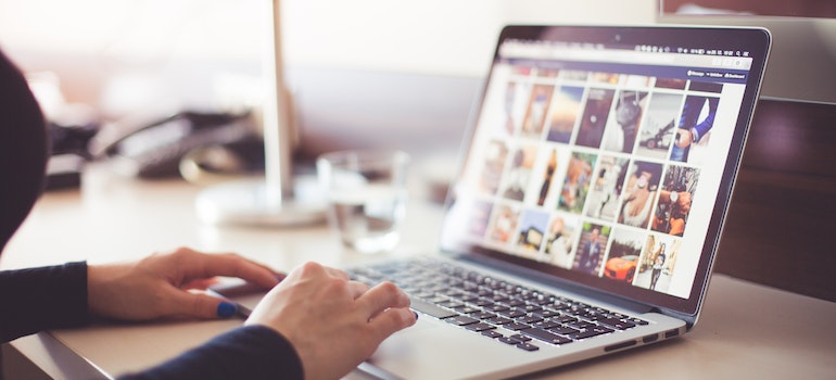 A person typing on a laptop and wondering can a Youtube Channel help your small business grow