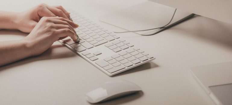 A person using a keyboard to write content that properly optimized for SEO in 2023